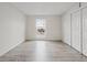 Bright bedroom featuring light wood floors, a window, and ample closet space at 2909 W 81St Ave # E, Westminster, CO 80031