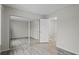 Bright bedroom featuring mirrored closet doors, light wood floors, and an open doorway at 2909 W 81St Ave # E, Westminster, CO 80031