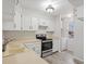 Well-lit kitchen with white cabinets, stainless steel appliances, and a view of the window at 2909 W 81St Ave # E, Westminster, CO 80031