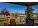 Outdoor patio with seating, a grill, and views of the landscape and mountains in the background at 551 Rio Rancho Way, Brighton, CO 80601