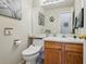 Clean bathroom featuring a comfort-height toilet and stylish vanity with countertop and faucet at 551 Rio Rancho Way, Brighton, CO 80601