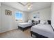 Bedroom with twin beds, neutral walls, ceiling fan, and a bright window with natural light at 551 Rio Rancho Way, Brighton, CO 80601