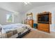 Bright bedroom with vaulted ceiling, large window, and classic wooden furniture at 551 Rio Rancho Way, Brighton, CO 80601