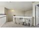 Bright hallway with carpet, white railings, and a ceiling fan, leading to the rooms on the upper level at 551 Rio Rancho Way, Brighton, CO 80601