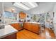 Bright eat-in kitchen with oak cabinets, light countertops, hardwood floors, and natural lighting at 551 Rio Rancho Way, Brighton, CO 80601