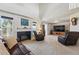 Cozy living room features vaulted ceilings, a fireplace, and comfortable furniture perfect for relaxing at 551 Rio Rancho Way, Brighton, CO 80601