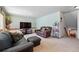 Cozy living room with plush seating, a large television, and carpeted flooring, perfect for relaxing at 551 Rio Rancho Way, Brighton, CO 80601