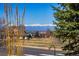 Scenic street view with mountain backdrop and charming neighborhood setting on a clear sunny day at 551 Rio Rancho Way, Brighton, CO 80601