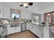 Modern kitchen with white cabinets, granite countertops, and stainless steel appliances at 18576 E Saratoga Pl, Aurora, CO 80015