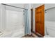 Bathroom showcasing a tub/shower combo with curtain, wood door, and wainscotting at 764 Blue Ridge Rd, Breckenridge, CO 80424