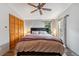 Charming bedroom featuring wood-look floors, ceiling fan, and ample natural light from the large windows at 764 Blue Ridge Rd, Breckenridge, CO 80424