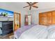 Bright bedroom with TV, drawers, closet, ceiling fan, and door leading to bathroom at 764 Blue Ridge Rd, Breckenridge, CO 80424