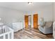 Bedroom features hardwood floors, a white dresser, and a grey rocking chair with floor lamp at 764 Blue Ridge Rd, Breckenridge, CO 80424