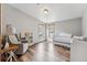 Bedroom features hardwood floors, a grey rocking chair, and white crib with baby mobile at 764 Blue Ridge Rd, Breckenridge, CO 80424