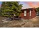 Charming log cabin exterior with mature trees and landscaped surroundings, nestled in a serene, natural setting at 764 Blue Ridge Rd, Breckenridge, CO 80424