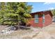 The exterior of this log cabin-style home is surrounded by mature trees at 764 Blue Ridge Rd, Breckenridge, CO 80424