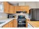 Cozy kitchen featuring wooden cabinets, modern appliances, and white countertops at 764 Blue Ridge Rd, Breckenridge, CO 80424
