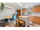 Bright kitchen with wood cabinets, central island, cozy seating and a view to the exterior at 764 Blue Ridge Rd, Breckenridge, CO 80424