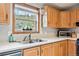 Bright kitchen featuring wooden cabinetry, stainless steel appliances and a large sink overlooking nature at 764 Blue Ridge Rd, Breckenridge, CO 80424