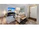 Inviting living room features a fireplace, comfy couch, TV, lots of light, and an adjacent entryway at 764 Blue Ridge Rd, Breckenridge, CO 80424