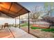Backyard featuring a covered patio, garden bed, and fenced yard at 4550 S Fox St, Englewood, CO 80110