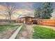 Backyard featuring grass area, patio with cover, and privacy fence at 4550 S Fox St, Englewood, CO 80110