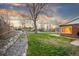 A lush backyard, with rock landscaping, and an expansive green space stretching from the home to the side fence at 4550 S Fox St, Englewood, CO 80110