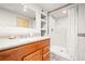 Updated bathroom featuring a vanity, built-in shelves and a tiled walk-in shower at 4550 S Fox St, Englewood, CO 80110
