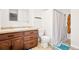 Bathroom with vanity, toilet, and shower featuring a striped curtain at 4550 S Fox St, Englewood, CO 80110