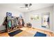 Bright bedroom with hardwood floors, modern ceiling fan, large mirror, and open closet at 4550 S Fox St, Englewood, CO 80110