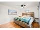 Bedroom features hardwood floors, stylish platform bed, and ample natural light at 4550 S Fox St, Englewood, CO 80110