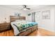 Well-lit bedroom featuring wood floors, modern ceiling fan, and platform bed at 4550 S Fox St, Englewood, CO 80110