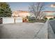 Charming brick home featuring a well-maintained front yard, long driveway and detached two car garage with a new door at 4550 S Fox St, Englewood, CO 80110