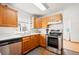 Kitchen features stainless steel appliances and a large sink with white counters at 4550 S Fox St, Englewood, CO 80110