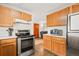 The kitchen features stainless steel appliances, lots of cabinets, and neutral countertops at 4550 S Fox St, Englewood, CO 80110
