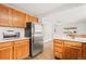 A bright kitchen with stainless steel appliances, white counters, and warm wood cabinets at 4550 S Fox St, Englewood, CO 80110
