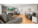 Inviting living room with a dark sectional, two armchairs, fireplace, and hardwood floors at 4550 S Fox St, Englewood, CO 80110