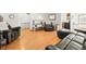 Open living room showcasing a hardwood floor and two seating areas that opens to other spaces at 4550 S Fox St, Englewood, CO 80110