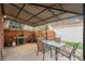 Covered patio with a dining table, grill and backyard access at 4550 S Fox St, Englewood, CO 80110