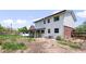 Spacious backyard with a white two-story home, grass and rock landscaping at 5199 Arbutus St, Arvada, CO 80002