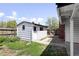 Backyard shed with a white exterior and a small garden area at 5199 Arbutus St, Arvada, CO 80002