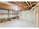 Unfinished basement featuring exposed wooden beams and built-in shelving at 5199 Arbutus St, Arvada, CO 80002