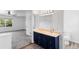 Bathroom featuring a vanity with stylish dark cabinets and a decorative mirror with lighting at 5199 Arbutus St, Arvada, CO 80002