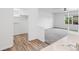 Bathroom with vanity, featuring wood floors, storage closet and a view to the large bedroom at 5199 Arbutus St, Arvada, CO 80002