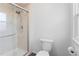 Bathroom shower with glass door, paired with a toilet and tile, offers a clean aesthetic at 5199 Arbutus St, Arvada, CO 80002
