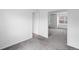 Bright bedroom with neutral walls and carpet, featuring an open doorway to another room at 5199 Arbutus St, Arvada, CO 80002