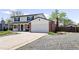 Two-story home with an attached garage and a spacious driveway at 5199 Arbutus St, Arvada, CO 80002