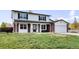 Charming two-story home featuring a well-manicured lawn and inviting front porch at 5199 Arbutus St, Arvada, CO 80002