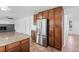 Spacious kitchen with stainless steel refrigerator, granite countertops, and tile flooring at 5199 Arbutus St, Arvada, CO 80002