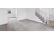 Carpeted living area with stairs leading to the upper level at 5199 Arbutus St, Arvada, CO 80002